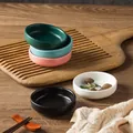 Nordic ceramic condiment dishes in assorted matte colors on a rustic wooden tabletop - Frosted Round Sauce Dish - Black