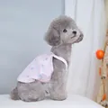 Close-up of pink bow print pet camisole on a grey poodle in a soft home setting - S / Pink