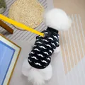 Detail of pet mustache fleece vest with reinforced leash ring and yellow leash attachment - S / Black