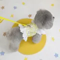 Close-up of a yellow newspaper print pet harness with white lace trim and metal D-ring - S / Yellow Newspaper Print Style