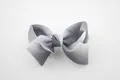 Close-up of a large grey and white gradient grosgrain ribbon bow with fine texture - Black