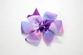 Detail of handmade grosgrain ribbon hair bow with colorful geometric triangle pattern - Geometric Dark Purple
