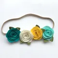 Detail of baby headband with four handmade felt roses in multi-colors and elastic band - Style 2 (Dark Cyan/Rice White/Yellow/Mint Green)