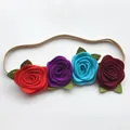 Detailed close-up of handmade felt rose headband with vibrant petals and green leaves - Style 4 (Red/Purple/Lake Blue/Dark Red)