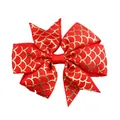 Close-up of red grosgrain hair bow with golden fish scale pattern and textured detail - Red