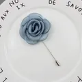 Navy blue fabric rose brooch featuring a long silver pin and elegant silk-like petals - Dusk Blue