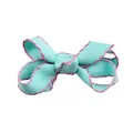 Macro detail of sky blue grosgrain bow with pink scalloped edges for DIY hair accessories - Blue