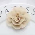 Macro detail of multilayer beige chiffon flower with central pearl for DIY fashion accessories - Khaki