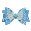 Close-up of blue glitter bow hairclip with white angel wings for girls hair accessory - Blue
