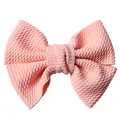 Detail view of the pink waffle fabric texture and soft knot on the girls hair bow clip - Snow Bud