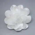 Detailed close-up of handmade white chiffon 3D floral ornament with layered petals - White