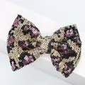 Close-up of DIY glitter sequin bow with leopard pattern for hair accessories and shoes - Pink