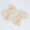 Set of two beige linen bow hair accessories with natural woven texture on white background - Beige