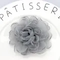Detail of multi-layered grey organza peony hair clip with delicate burnt edges on ceramic - Silver Gray