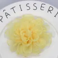 Detailed macro view of the layered light yellow organza petal textures on a floral hair clip - Light Yellow
