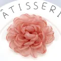 Detailed macro view of handmade pink organza peony flower hair clip with layered petals - Coral