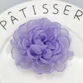 Macro shot of purple layered organza flower hair clip on a white ceramic plate - Light Purple