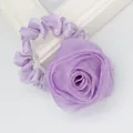 Macro detail of elegant purple fabric rose hair tie showing layered organza petals - Purple
