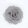 Macro detail of elegant grey organza camellia brooch with layered fabric petals - Flat Pad / Gray