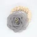 Détail d'un chouchou fleur en mousseline grise avec ruban satin et perles fines - Gris