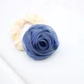 Detail of a large blue mesh rose hair tie with creamy white satin fabric texture - Navy Blue