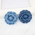 Detailed view of layered denim camellia flowers in light and dark blue with frayed edges - 5cm Deep Denim Camellia