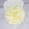 Macro detail of creamy yellow satin fabric flower with delicate layered petals craft - Beige
