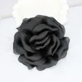 Detailed view of a handmade black satin rose flower accessory on marble background - Black