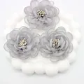 Detailed view of handmade grey organza fabric camellia flowers with pearl stamen center - Flat Pad / Gray