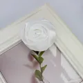 Close-up of a white satin ribbon rose bud with green leaf for DIY crafts and accessories - Flat Pad / White