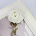 Macro detail of white satin rose bud accessory with green leaves on decorative background - Flat Pad / Beige