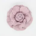 Detailed macro of a handmade vintage denim camellia flower hair accessory in dusty pink - Flat Bottom Style / Elegant Purple