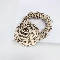 Vintage leopard print rose hair scrunchie with large fabric flower on marble background - Beige