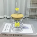 Glass tumbler with bamboo lid and straw featuring 3D yellow ribbon bow accents - Yellow