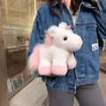 Detail of soft white faux rabbit fur unicorn plush toy held by a model in denim jacket - Pink Dreamy Unicorn