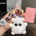 Close-up of white plush bear pendant with sunglasses, knit hat, and heart charm - White