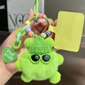 Macro detail of a plush green bear keychain featuring a knit hat and sunglasses - Cute Green