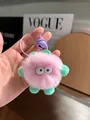 Detail of pink faux fur pompom keychain with green ears and a purple metallic bell - Light Purple