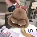 Cute brown rabbit plush keychain with burgundy checkered bow and fluffy fur texture - Brown