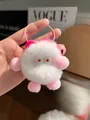 Close-up of cute plush monster keychain with soft white fur and pink woven lanyard charm - Light Pink