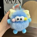 Detalle de llavero de monstruo en piel sintética azul con lazo amarillo y cadena - Azul