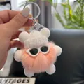 Close-up of cute pink plush charm with white knitted hat and silver metal keychain - Light Orange