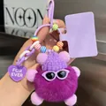 Close-up of a purple faux fur ball charm with a knit hat, sunglasses, and heart tag - Purple