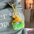 Cute green faux fur monster keychain with yellow knit hat on a denim bag - Green