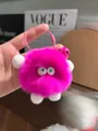 Cute bright pink plush monster keychain with fluffy fur and a decorative pink bell - Rose Red