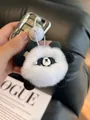 Detail of a fluffy panda plush keychain with white pearl eyes and soft faux rabbit fur texture - Style 1 Panda (With Pearl Decor)
