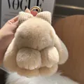 Detail of soft beige plush bunny keychain with a plaid bow and gold metal ring - Milk Tea