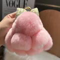 Detail of pink fluffy bunny keychain with a green plaid bow and golden metal ring - Light Pink