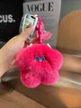 Detailed view of fluffy rose pink plush flower pendant with blue eyes and silver keychain - Berry Pink