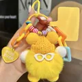 Close-up of yellow faux rabbit fur keychain with knitted hat, glasses and heart charm - Cute Yellow